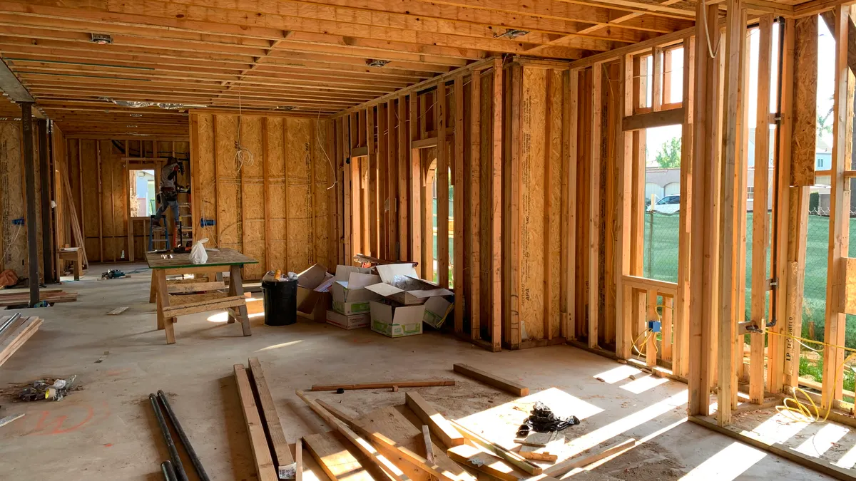 Wood-framed house interior with studs and ceiling framing
