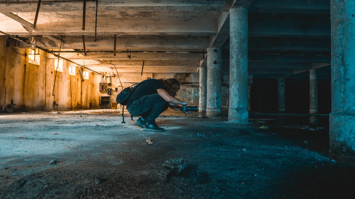 What Are Crawl Space Piers Made Of? crouching in a low basement with concrete columns